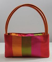 Front and sides view of the handwoven silk handbag featuring bright orange, red, green, and pink vertical stripes.