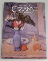 Front cover of The Art of Cezanne book showing a still life painting with blue vase and flowers