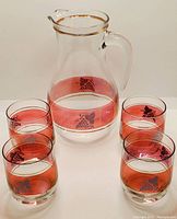 Full set of one pitcher and four glasses showing cranberry flash and grape design.