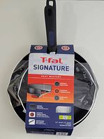 T-Fal Signature Heat Mastery pans packaging highlighting 9.5" and 12" pans with Thermo-Spot, durable non-stick, even heat base, and easy grip handles.