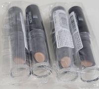 Four tubes of unopened Revlon Photoready Concealer #006 wrapped in plastic, showing the product from the front and side with visible shade color.
