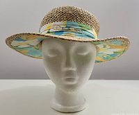 Front view showing the straw weave, wide brim, floral fabric band, and embroidered Panama Jack logo.