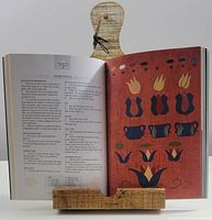 Front view showing cookbook stand holding an open cookbook, illustrating usage and scale.