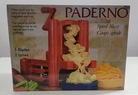 Front of the box showing the red Paderno spiral slicer with spiral-cut vegetables and the text highlighting 3 blades and spiral cuts for vegetables and fruits.