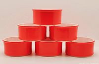 Stacked view of six red ceramic ramekins showing bright red exterior.