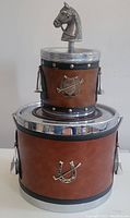 Front and top view of the vintage equestrian themed ice bucket and ashtray set showing horse head lid and equestrian emblems