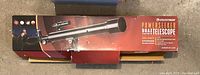 Retail box top showing Celestron Powerseeker 50AZ telescope image and branding.