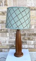 Front view of the vintage teak table lamp showing the wood base and printed fabric shade.