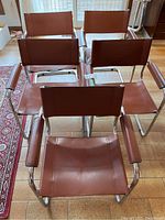 Overhead view of five chairs arranged on floor.