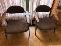 Pair of armchairs side by side in front of window showing overall appearance