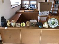 Wide shot of all ten decorative items displayed on wooden counter