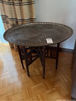 Assembled brass tray on wood folding base, full view