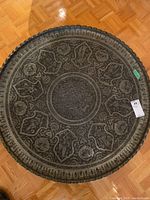 Top view of entire round tray showing full stamped design and scalloped rim