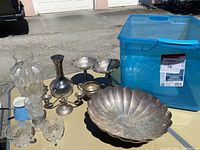 Overview of lot: crystal vase, silver bud vase, compote dishes, candlestick holder, sugar bowl, scalloped bowl, glasses and enamel creamer
