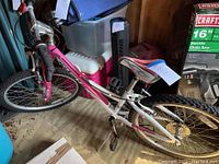 Full view of the pink and white girls Trek bicycle showing frame, seat, handlebar, and tires.