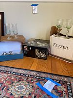 Overall display including boxed Viscount punch set, wine glasses with ring markers, and box with flatware