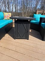 Side view of rectangular fire pit table showing metal frame and tabletop