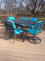 Full view of the rectangular table on deck alongside chairs (chairs sold separately)
