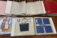 Overview of binders open with various Disney scrapbooking layouts visible including Donald Duck and Mickey Mouse themes.