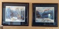 Pair of framed Julie Kramer Cole prints hung side by side on wall showing winter scenery with horses
