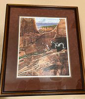 Front view of the framed print showing a Western canyon scene with a cowboy and horse, signed by the artist.
