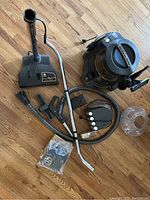 Entire Rainbow vacuum system with basin, hose, wands and accessories arranged on wooden floor