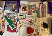 Overview of stickers, scrapbooking paper, scrap pads, and decorative paper including various sticker sheets and cardstock.