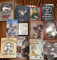 Photo showing all nine items: one Miller High Life advertising mirror and eight reproduction advertising tin signs.
