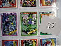 Close-up photo showing three Marvel Universe trading cards including She-Hulk and a Super-Villain with chromed artwork.
