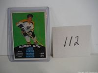 Front of the 1970-71 O-Pee-Chee Bobby Orr hockey card showing player in Boston Bruins uniform with Norris Trophy winner details.
