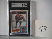 Front view of 1984-85 Wayne Gretzky Topps hockey card in protective SGC graded case showing 5.5 grade.