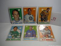 Full view of six 1970-71 OPC hockey cards arranged in two rows of three, showing players with team names and positions.