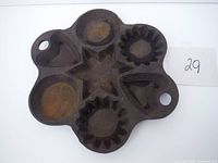 Top angle view showing all five mold cavities and two handles with holes.