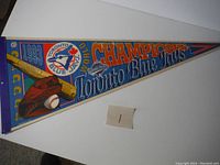 Full view of the vintage 1993 Toronto Blue Jays World Series Champions pennant with team logo, graphics, and text.