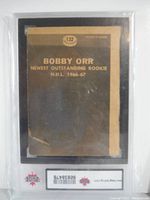 Back side of Bobby Orr 1966-67 Topps "Newest Outstanding Rookie" card showing puzzle piece information
