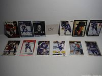 Collection of 11 hockey cards featuring Doug Gilmour and Wendel Clark displayed on a white surface, showing front of the cards with player images and text.