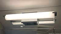 Front and side views of the modern rectangular wall light fixture mounted on ceiling or wall surface, showing frosted glass and polished metal frame in chrome or brushed nickel finish.