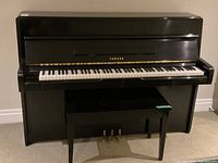 Full front view of piano with bench