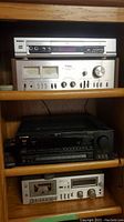 Shelf with four stereo components: Crystal CAV-685, Technics SU-7700, Pioneer VSC-D701 S and Technics M-33 tape deck