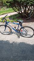 Side profile of blue Supercycle SC1800 bicycle showing entire frame, tires, seat and handlebars