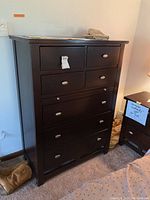Front view of the tall dresser showing all seven drawers and finish.