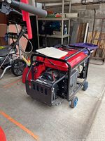 Full view of Honda EM500S generator in garage showing frame, wheels and control panel
