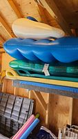 View of stacked floats showing white ring and blue raft on top of foam pads