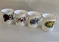 Four Rosina fine bone china tea mugs with unique floral patterns displayed side by side on a neutral background