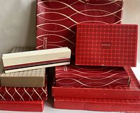 Stack of various vintage Eaton's cardboard gift boxes in red, beige, and white, showcasing multiple patterns and the Eaton's branding