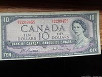 Front view of the 1954 Canadian $10 bill showing the Queen's portrait, serial number, and signatures.