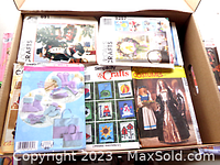 Box showing various vintage sewing pattern envelopes including Simplicity Crafts and Butterick Christmas craft patterns