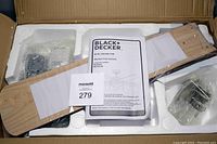 Factory sealed box with ceiling fan blade and instruction manual visible in styrofoam packaging.