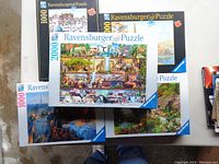 Six Ravensburger puzzles laid out on table, showing variety of box designs and sizes