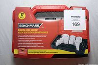 Front view of factory sealed red Benchmark bi-metal hole saw set case with product info and images.